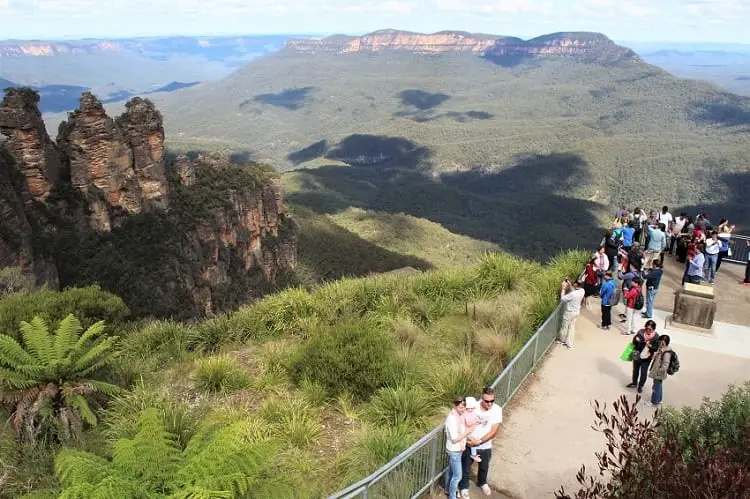Tourists admiring the Three Sisters rock formation in the Blue Mountains.