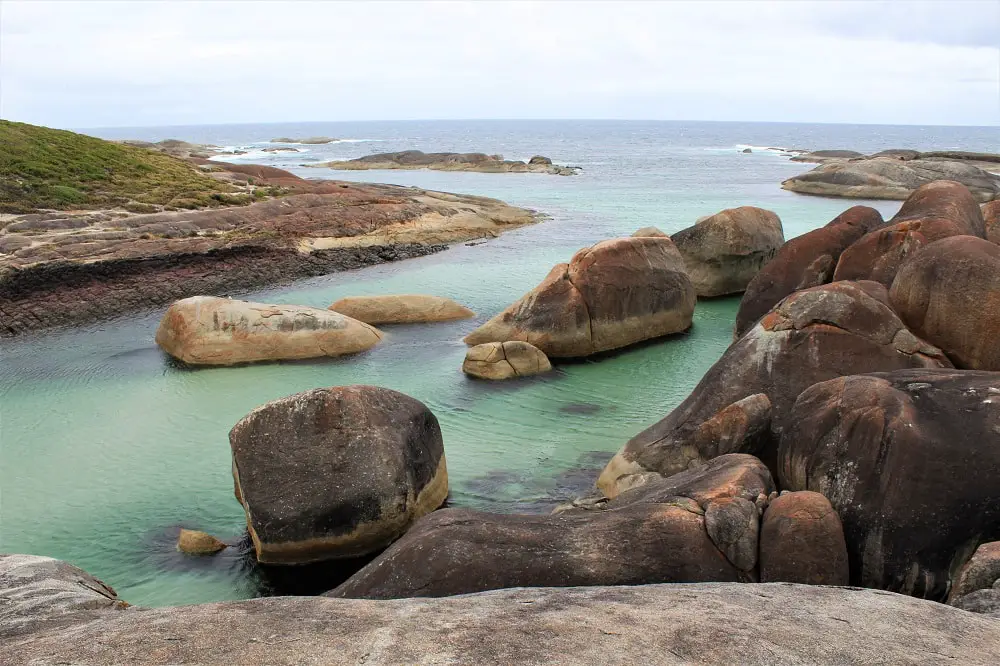 Green water and orange rocks at Elephant Rocks in Denmark, WA.