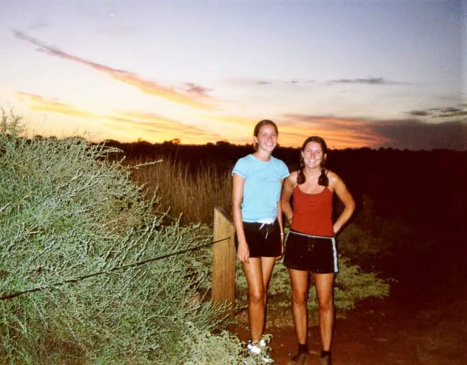 Travel blogger Lisa Bull with a friend on a trip to Ayers Rock as a student.