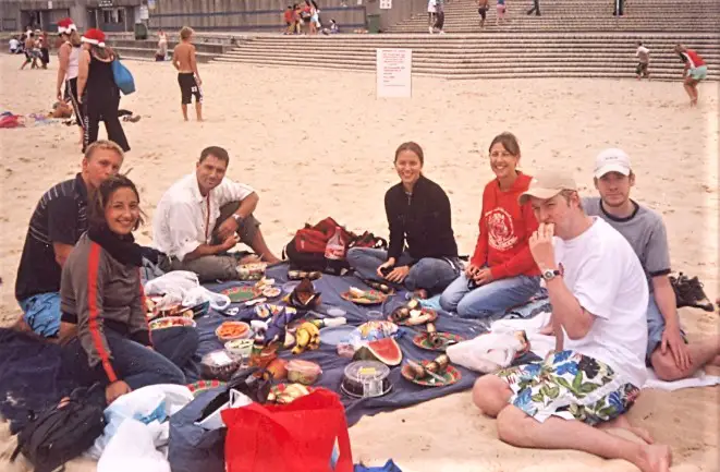 Group of backpackers having a picnic at Coogee Beach for Christmas.