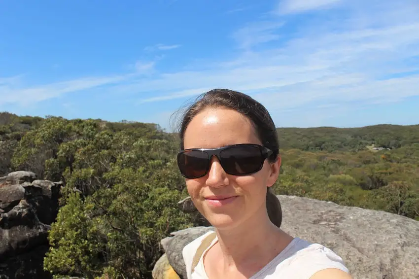 Travel blogger and YouTuber, Lisa Bull, from Australian travel blog Dreaming of Down Under, on the Coast Track at Wattamolla Beach, Royal National Park.