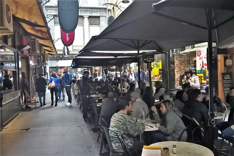 Outdoor seating outside Melbourne cafes along Degraves Street in winter.