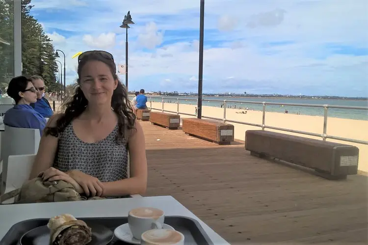 An expat enjoying coffee and cake at Brighton Le Sands beach café in Sydney.