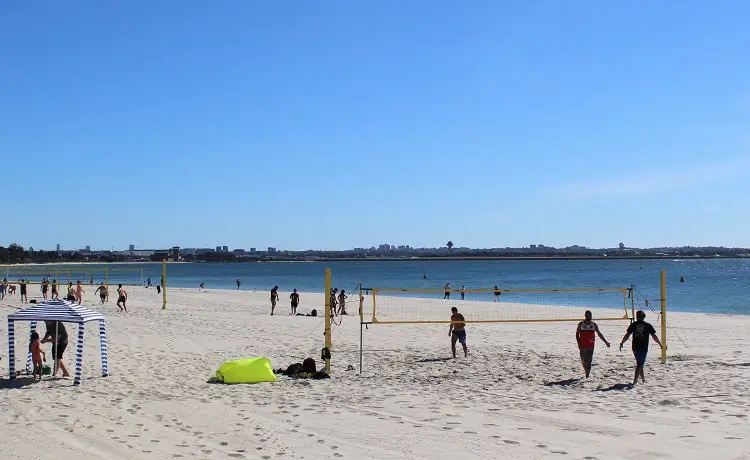 Sydneysiders playing volleyball on a sunny Sunday morning at Brighton Le Sands Beach.