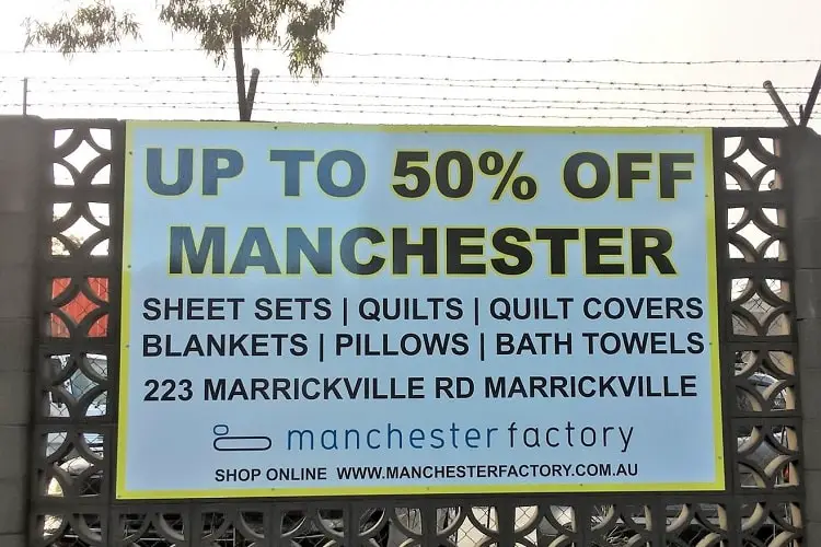 A sign advertising a sale on Manchester in Australia (bedding and towels).