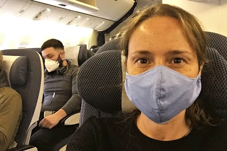 British expat in a face mask on a BA flight returning to Australia during Covid-19.