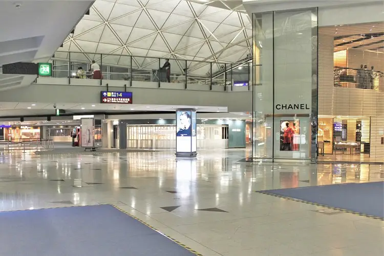A deserted Hong Kong Airport with closed shops in July 2020 because of reduced passengers flying during Covid-19.