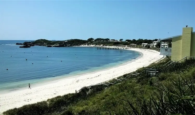 Stunning photograph of Geordie Bay on Rottnest Island, showing holiday accommodation overlooking a white beach with turquoise water,