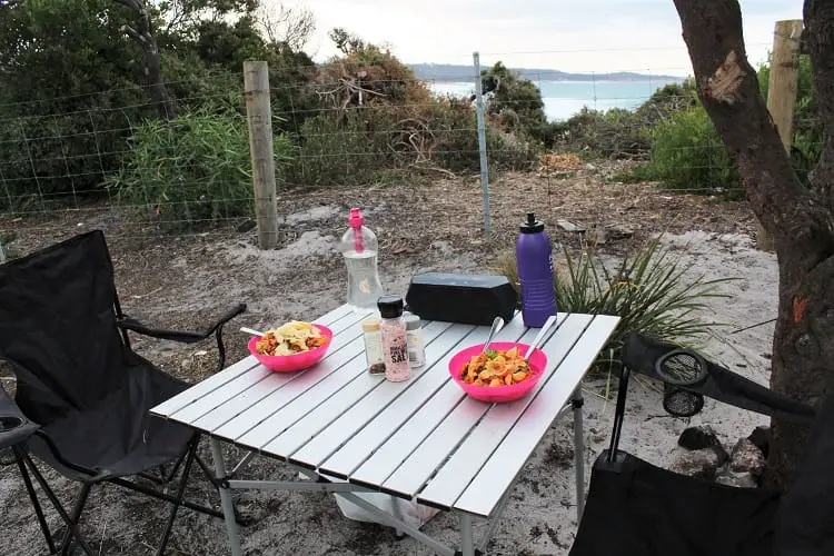 Camping dinner with sea views at Stumpys Bay Campground in Tasmania.