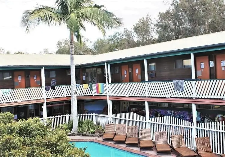 Swimming pool and dorm rooms at Arts Factory Lodge, a backpacker resort in Byron Bay.