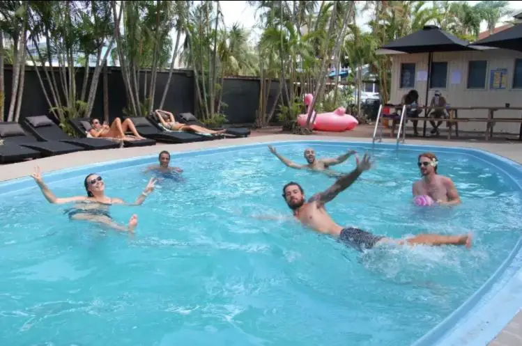 Travellers having fun in a pool at an Australian hostel.