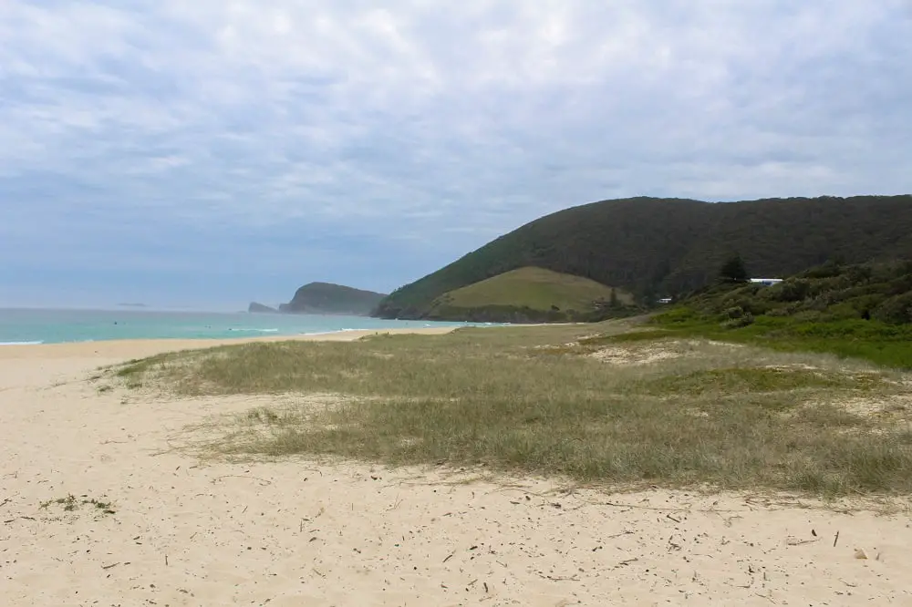Blueys Beach with green hills in the background.