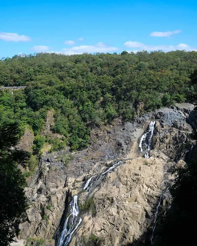 Barron Falls viewed from the Cairns skyrail lookout, with the scenic railway in the distance.