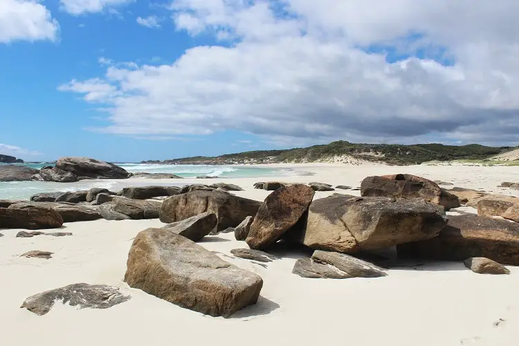 Beautiful Redgate Beach in Margaret River with boulders in the foreground.