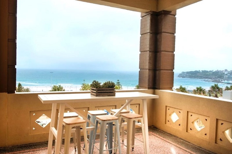 Balcony with seating and an ocean view at Hotel Bondi in Sydney, Australia.